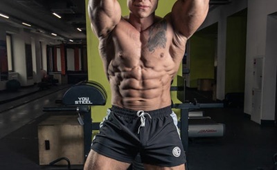 lean bodybuilder flexing his abs